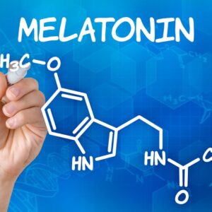 Hand with pen drawing the chemical formula of melatonin.